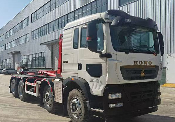 Hook arm garbage truck
